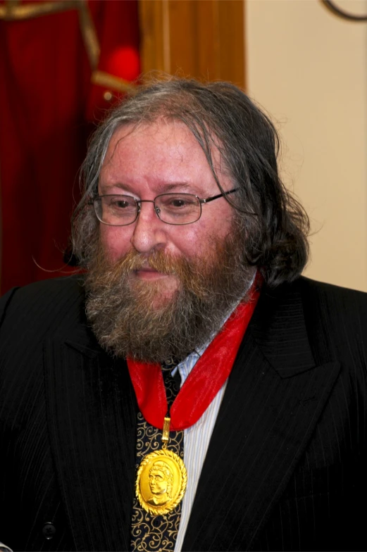 there is a man wearing a long beard with his award medals