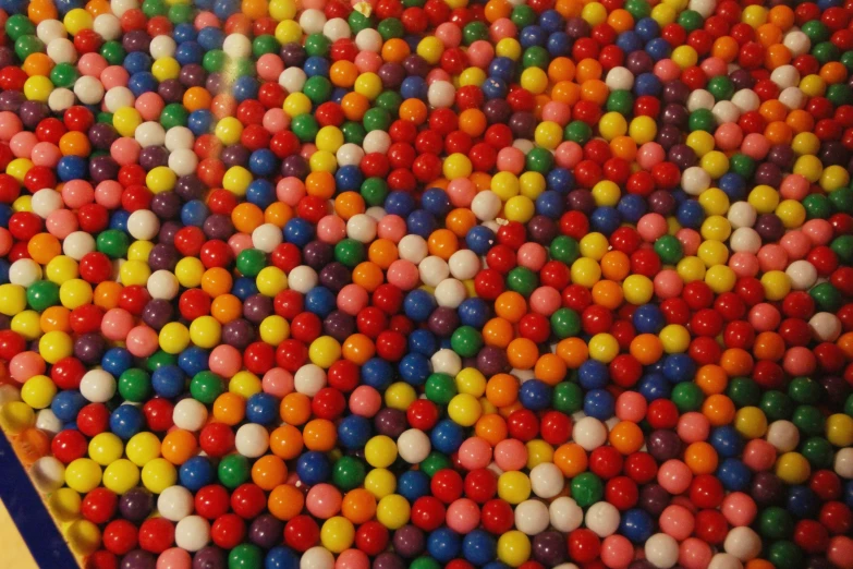 a bunch of colorful balls are scattered about a large table