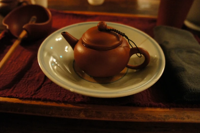 a tea pot is on a white plate