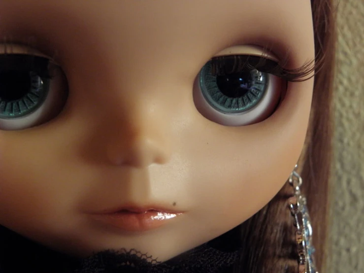 close up of a doll's face with long brown hair