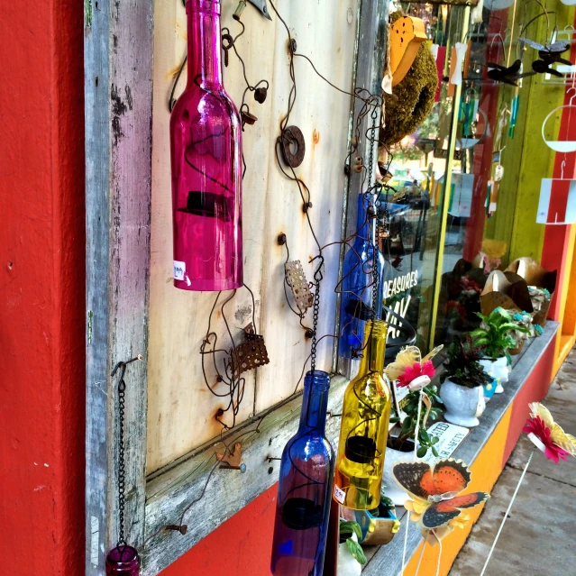 a window with some bottles of wine hanging