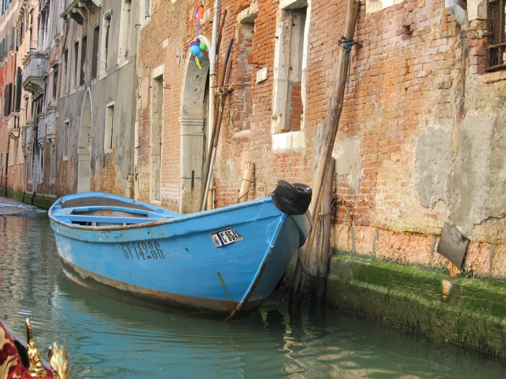 there is a blue boat sitting in the water