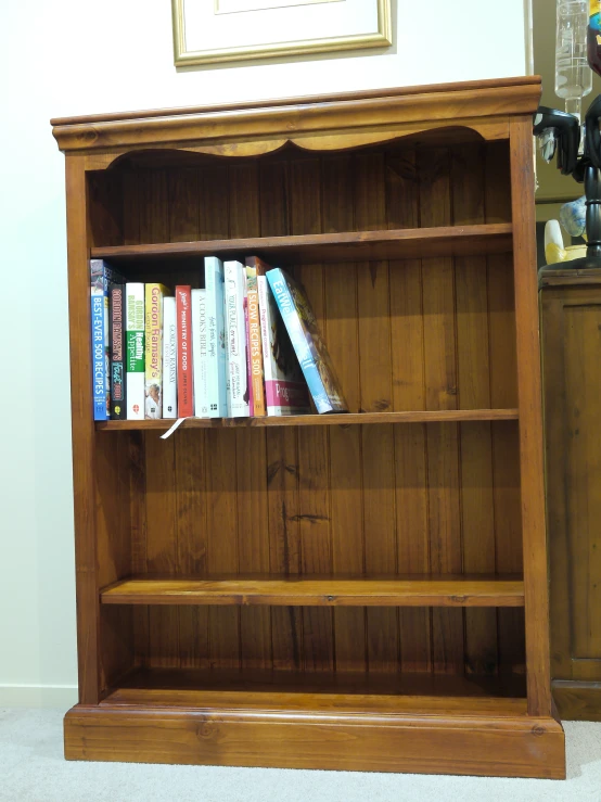 an old wooden book shelf full of books