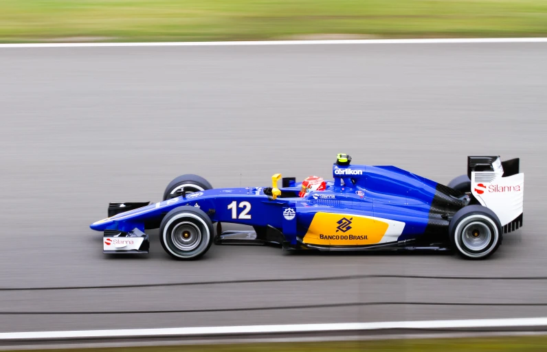 a car with blue paint drives down the track