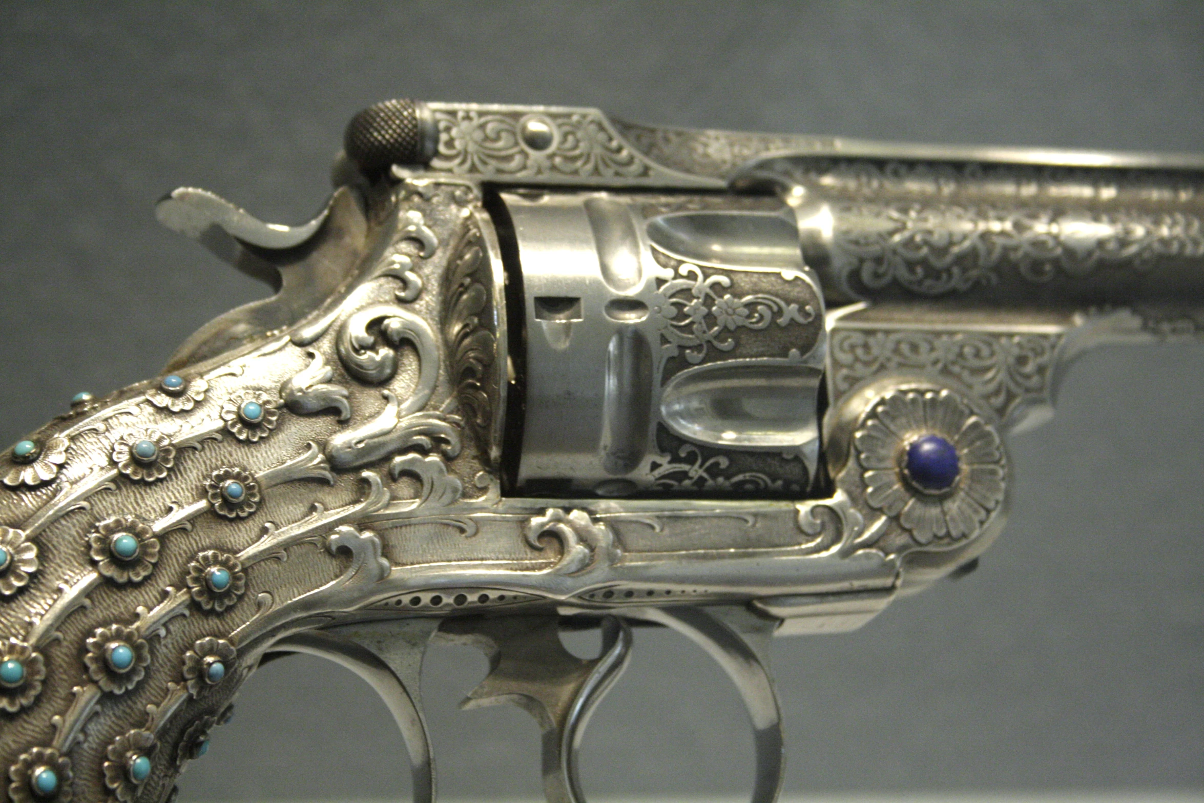 the antique pistol is sitting on display on a stand