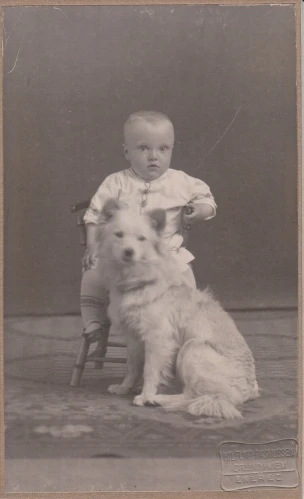 an old picture of a baby and a dog