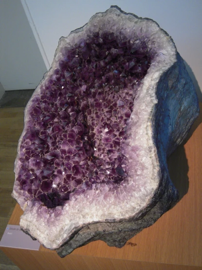 a cluster of purple and white rock on top of a table