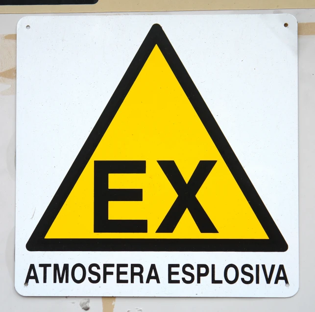 a yellow triangle is above a black ex sign