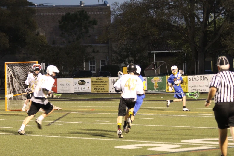 some players are running on a field playing soccer