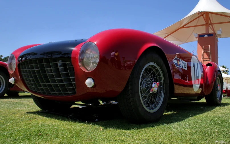 a very unique car sitting outside on the grass