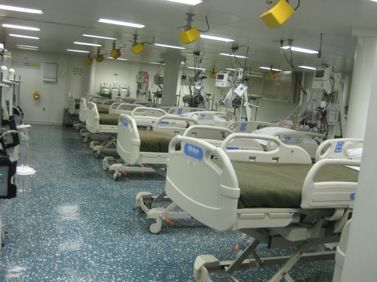 rows of beds that are sitting inside of a room