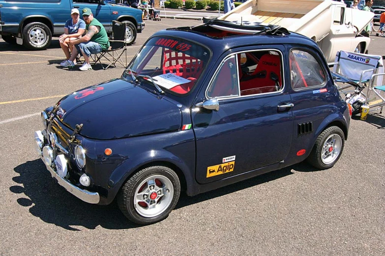 a small, blue car with a yellow sticker on it