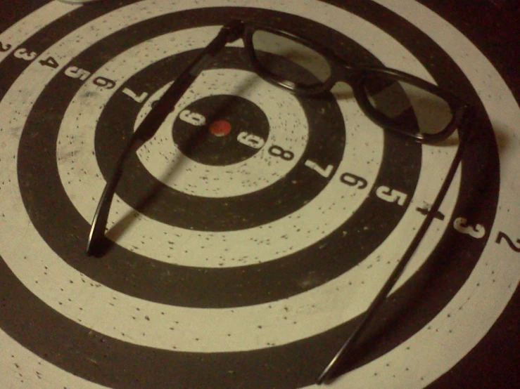 black sunglasses on white target on black and white floor