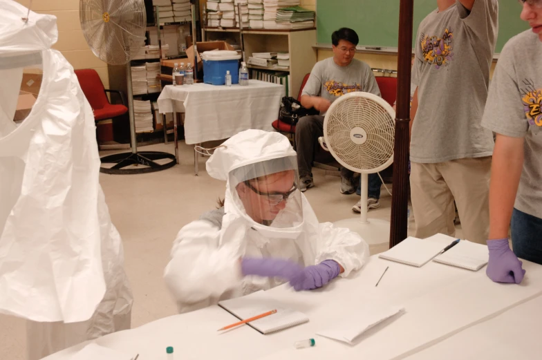 some people wearing protective gear in front of a fan