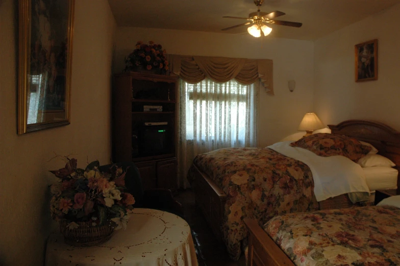 a room with two beds and an entertainment center