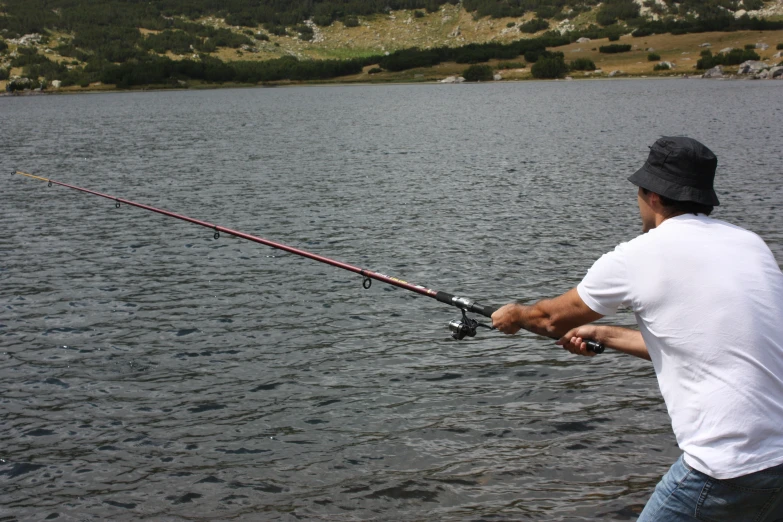 a man fishing in the water with his fishing rod