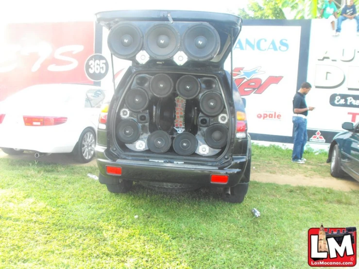 an open car trunk in the middle of a lawn