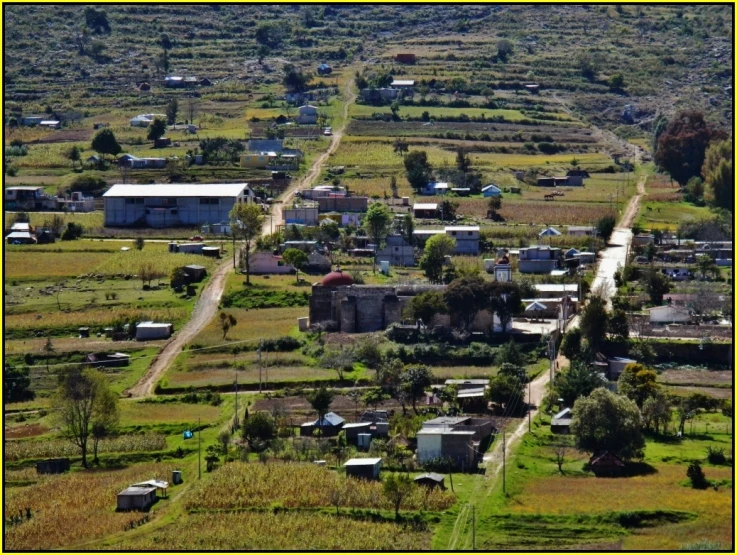an aerial view of a town with several buildings