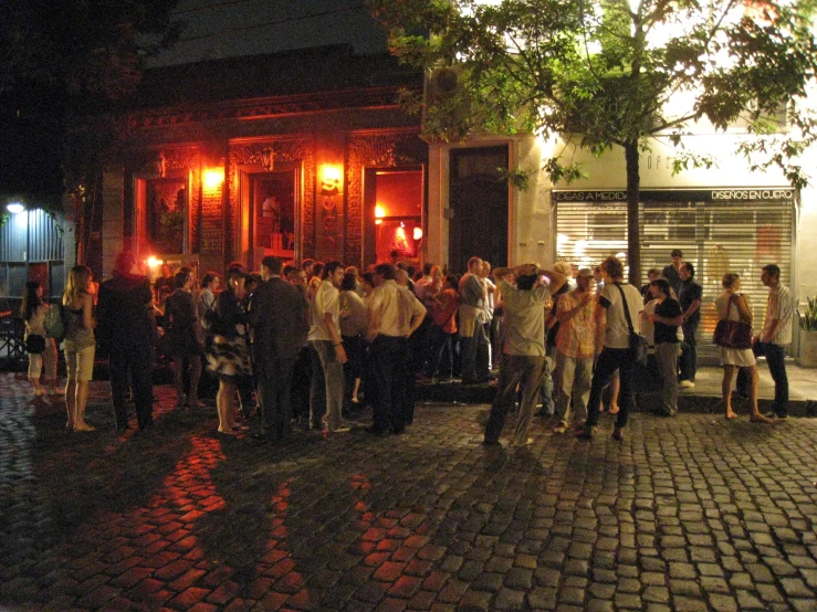 there is a crowd gathered at the entrance to a building