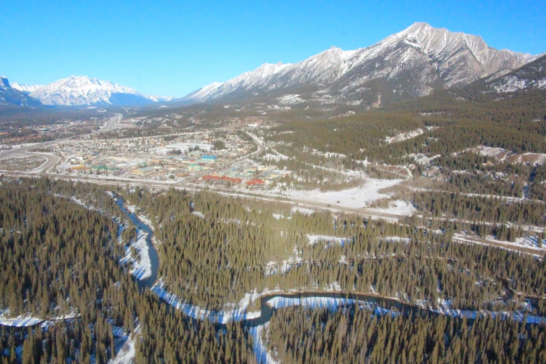 a view from a plane of the resort with snow covered mountains