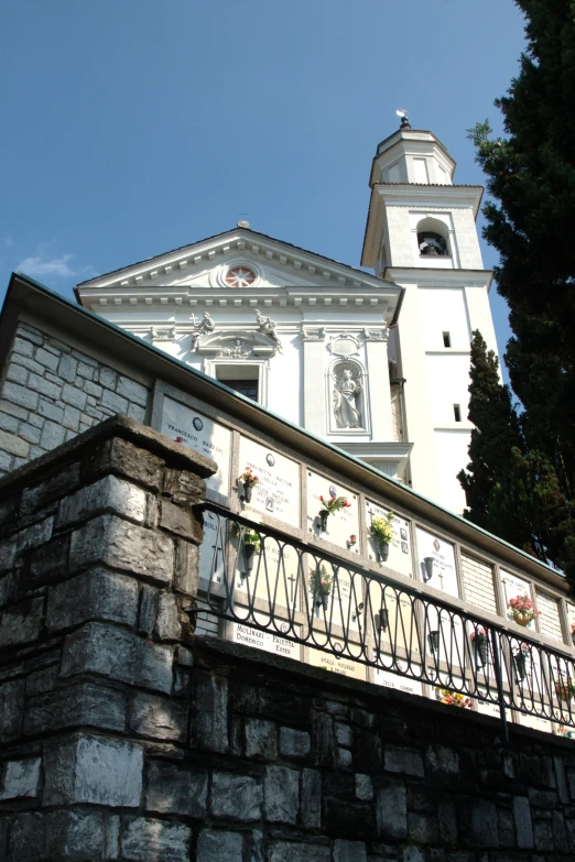 a building with a tower with a clock and a balcony