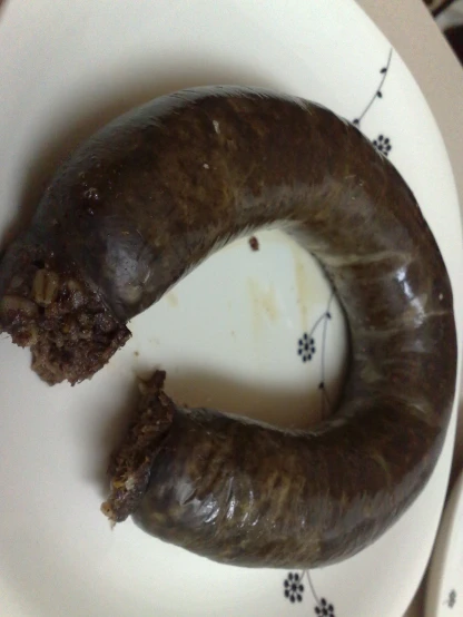 a eaten sausage sitting on top of a plate
