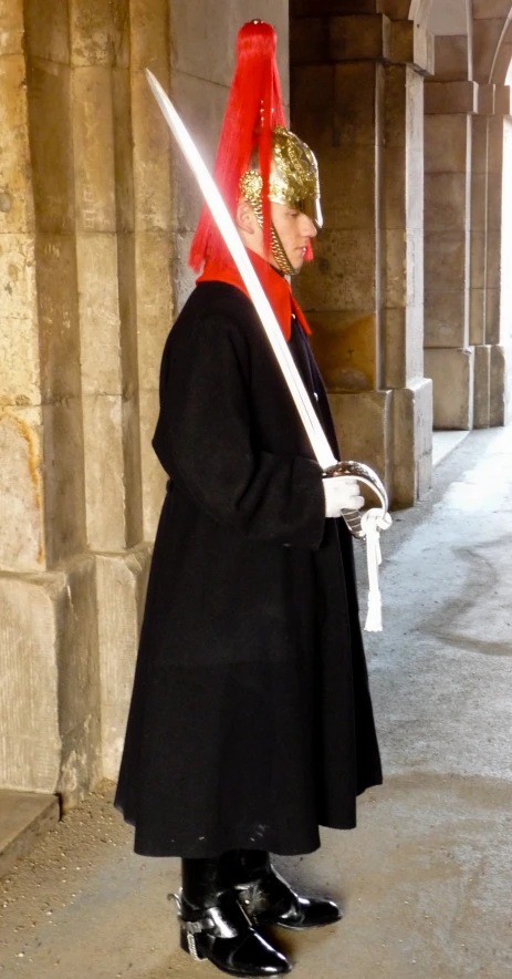 a man dressed as a person holding a sword