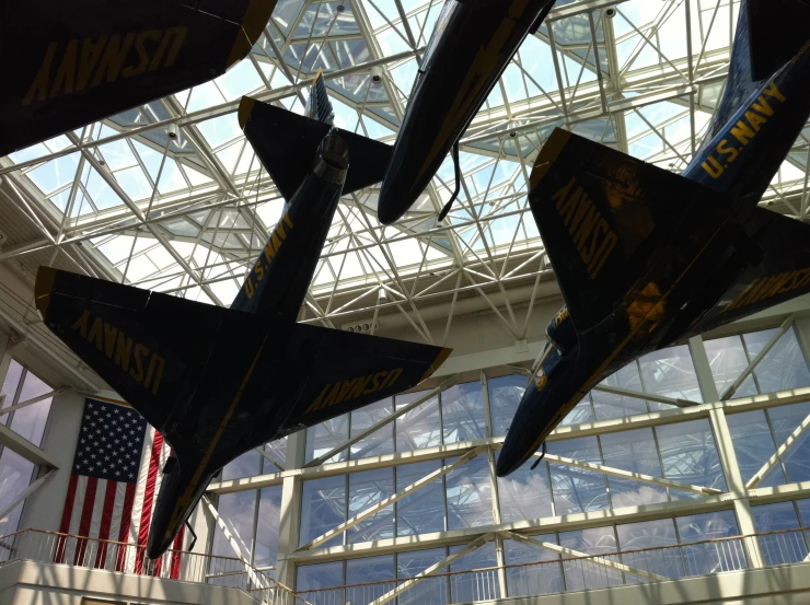 several jets are suspended in an air museum