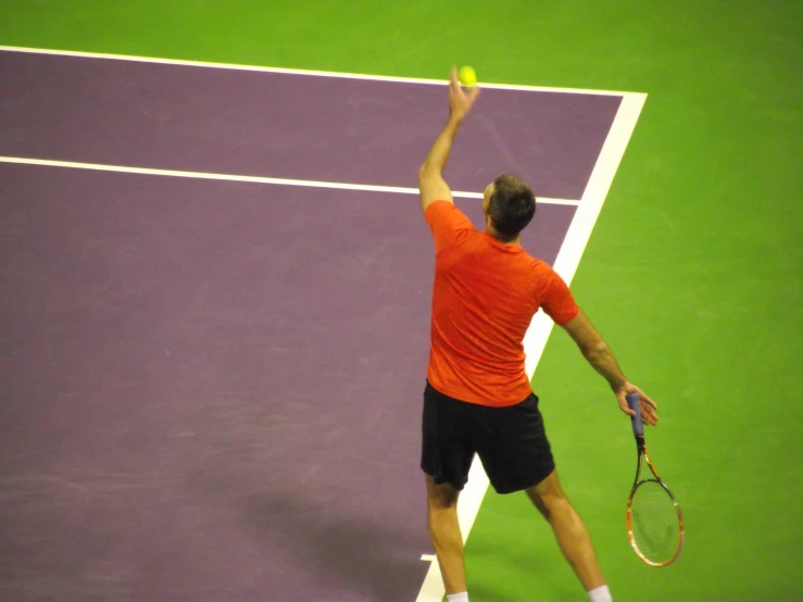 a tennis player is raising his arm in victory