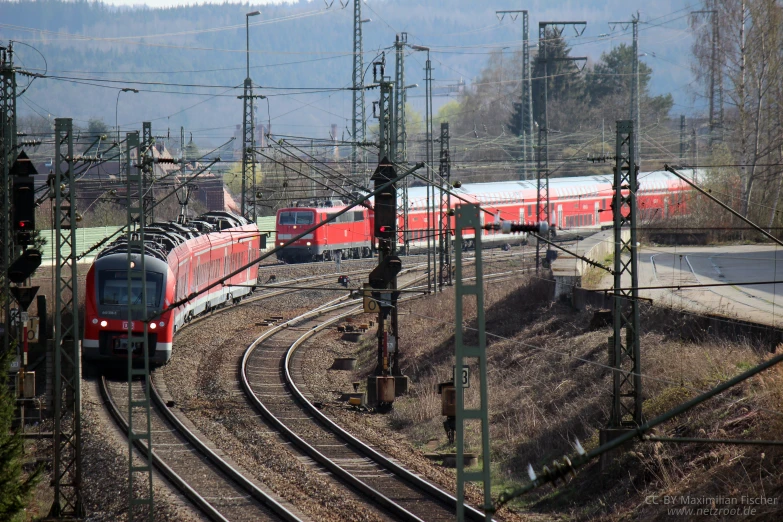 red train pulling many cars on a track