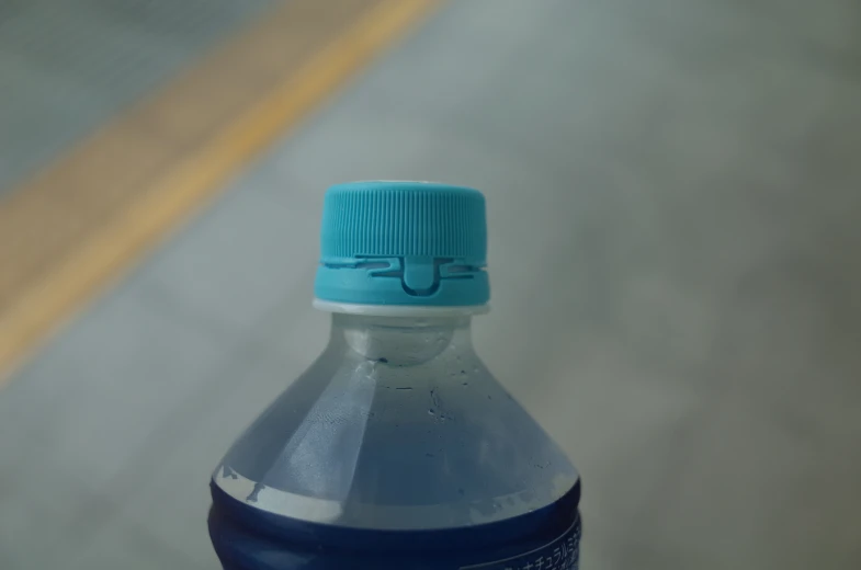 a blue bottle of water sitting on a surface