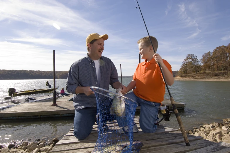 there are two men standing on a pier fishing