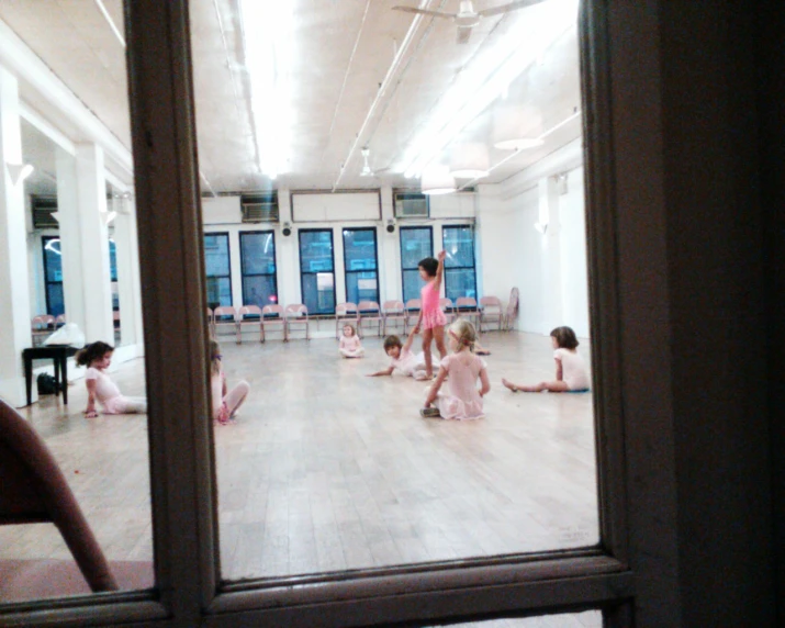 young children doing yoga in an open room