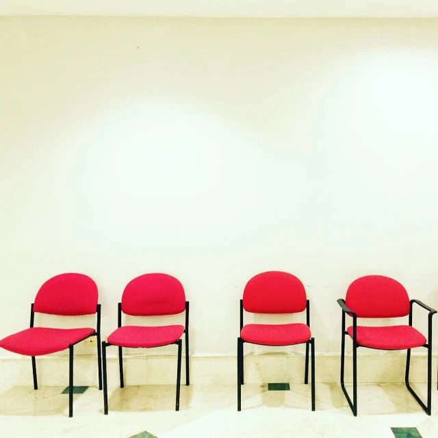 a line of chairs in a white room