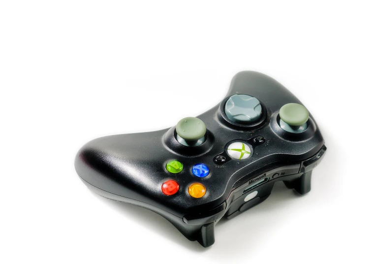 a black game controller sitting on top of a table