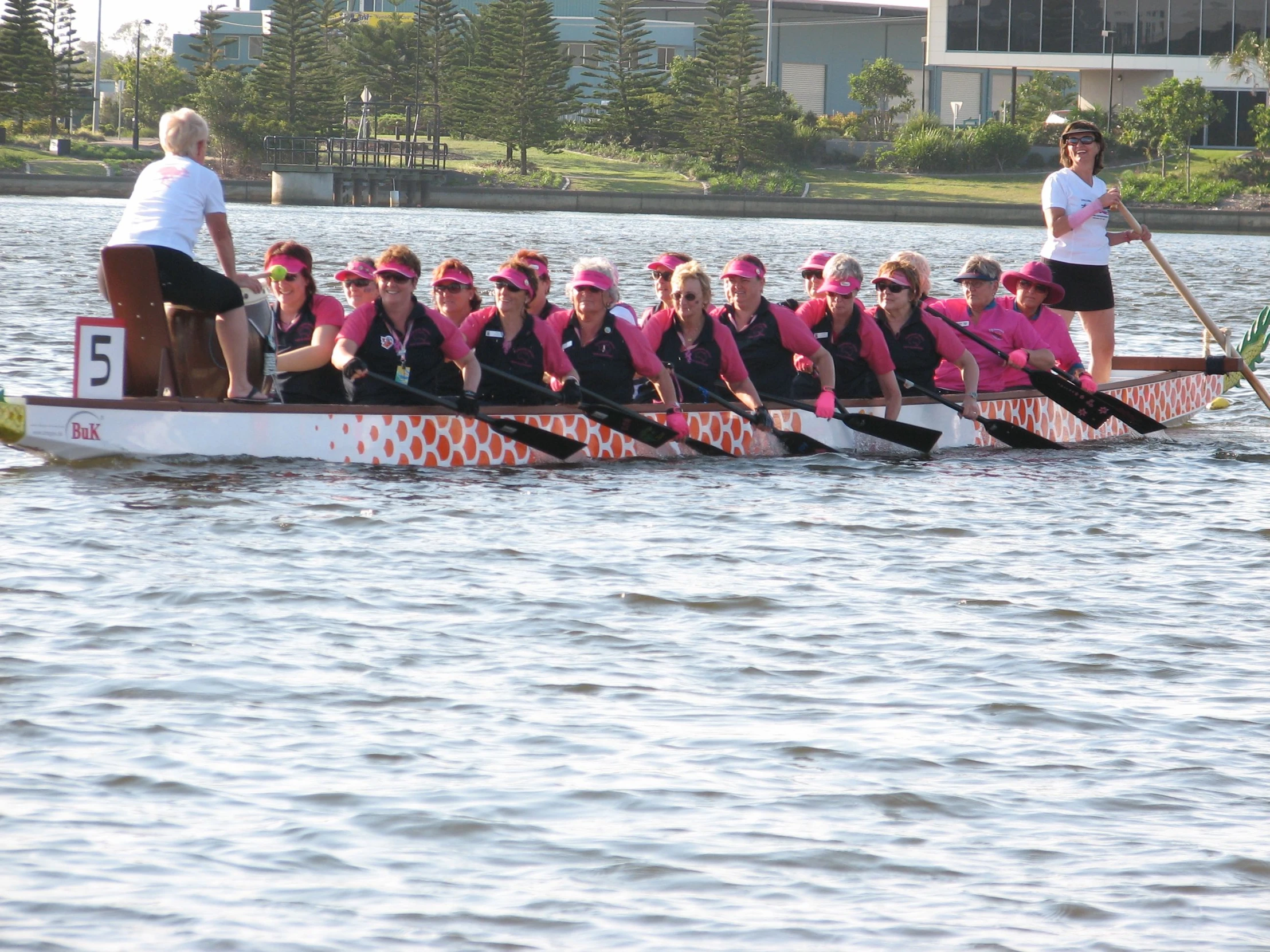 a paddle boat is full of women's competitive rowing team