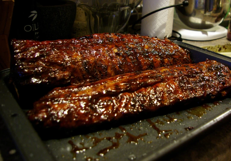 two barbecue ribs are shown on a metal grill