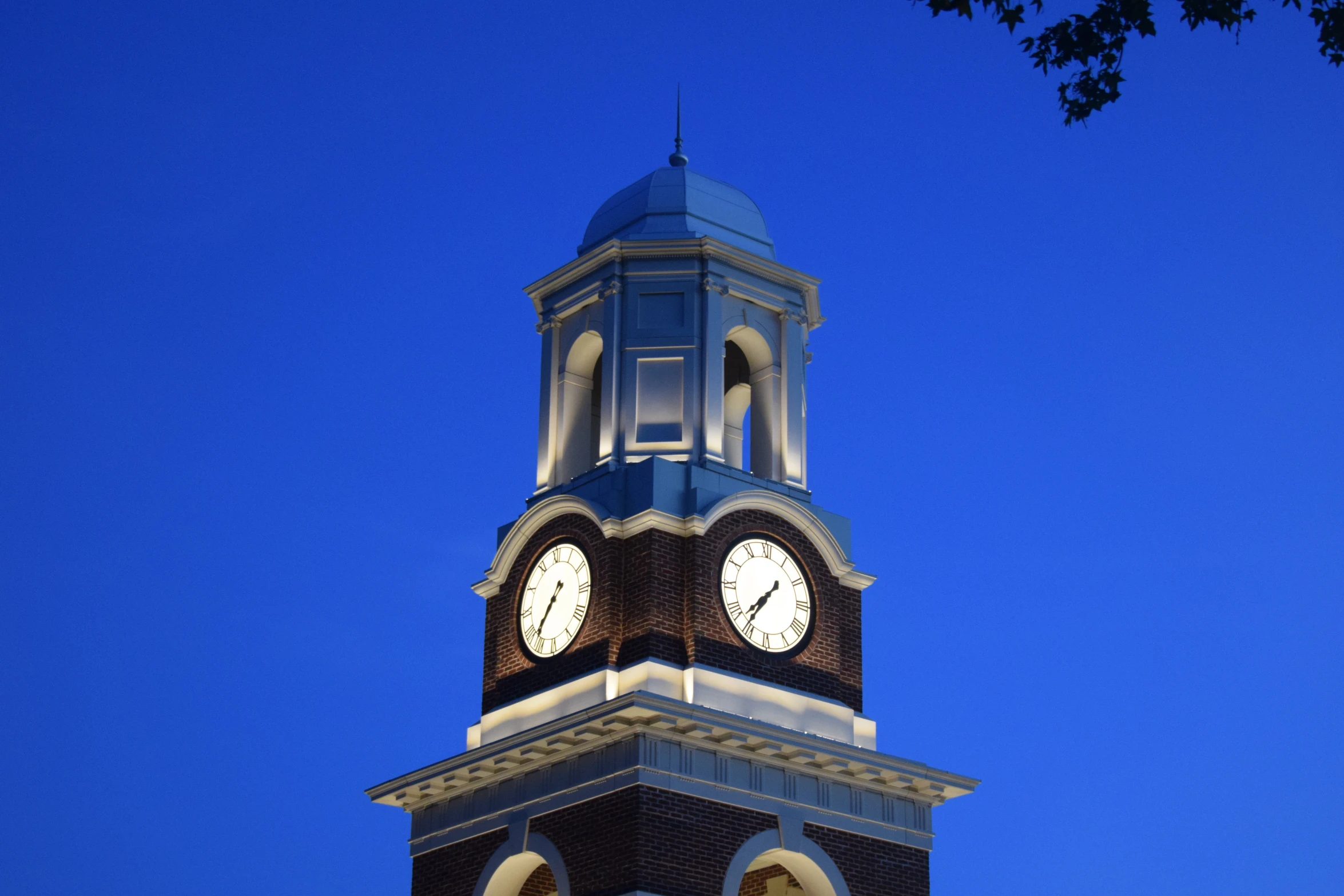 a clock on top of a building with a blue sky in the background