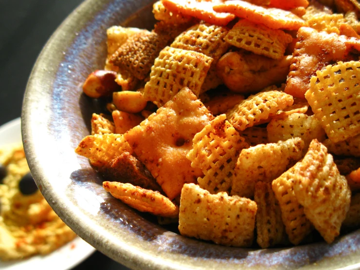 a bowl of cheetah ers next to other snacks