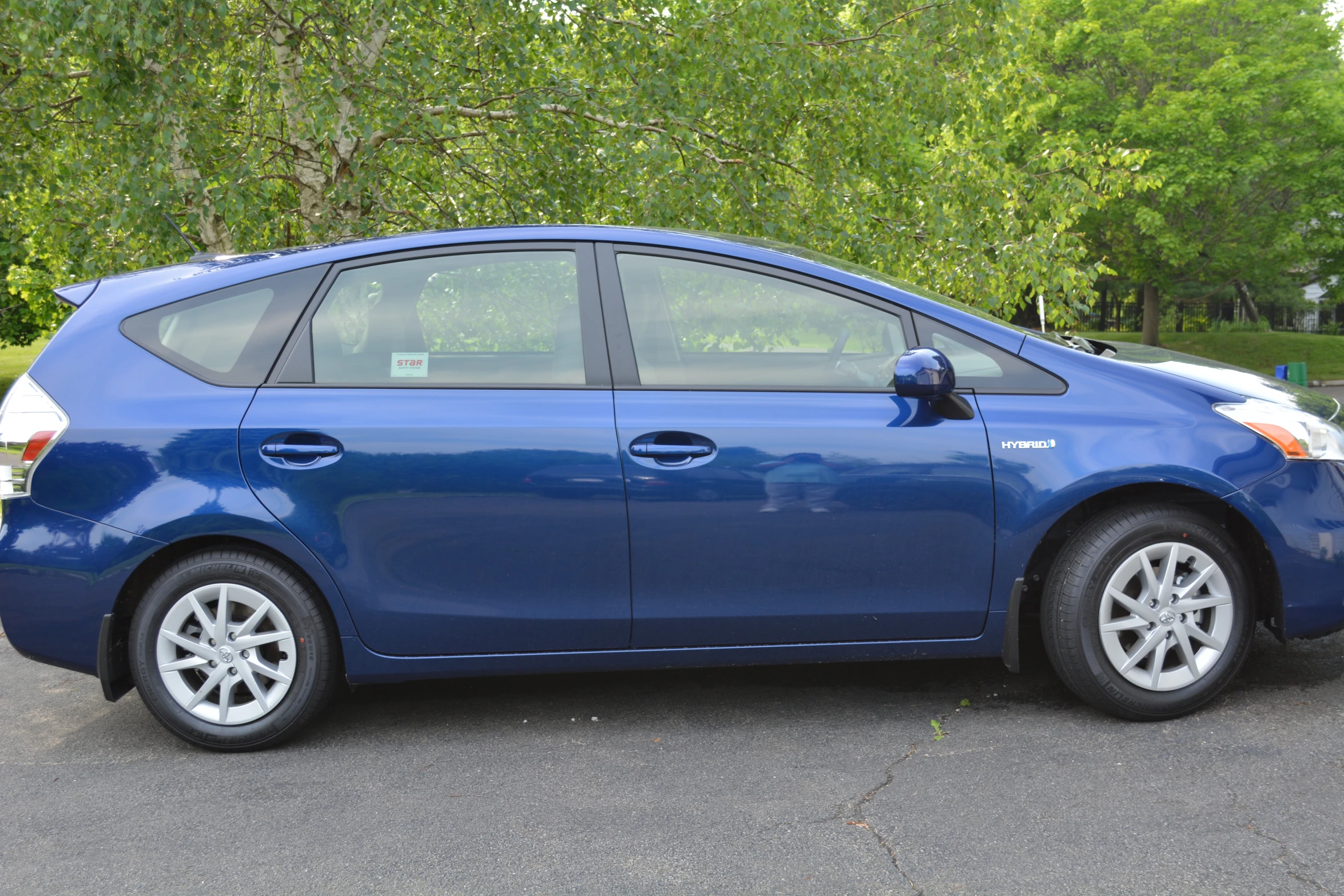 a blue hatchback car is parked in a lot