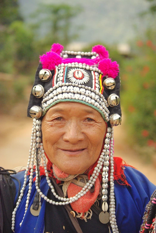 the asian woman is wearing a beaded head piece