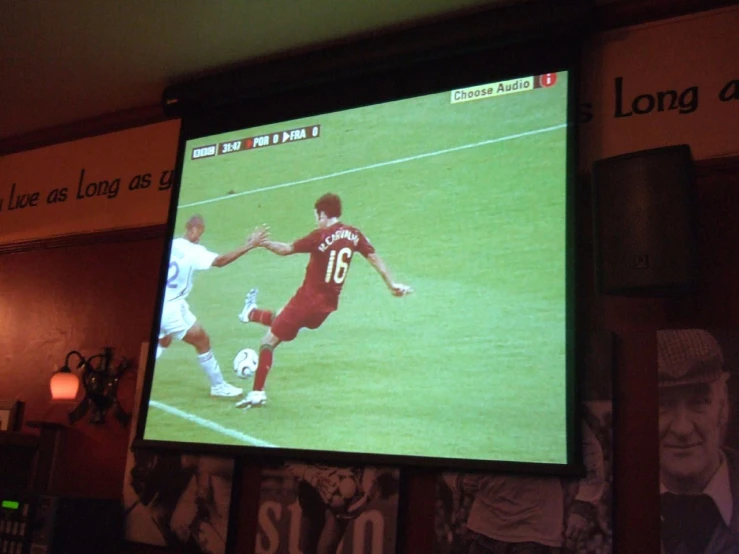 a television screen showing two men playing soccer