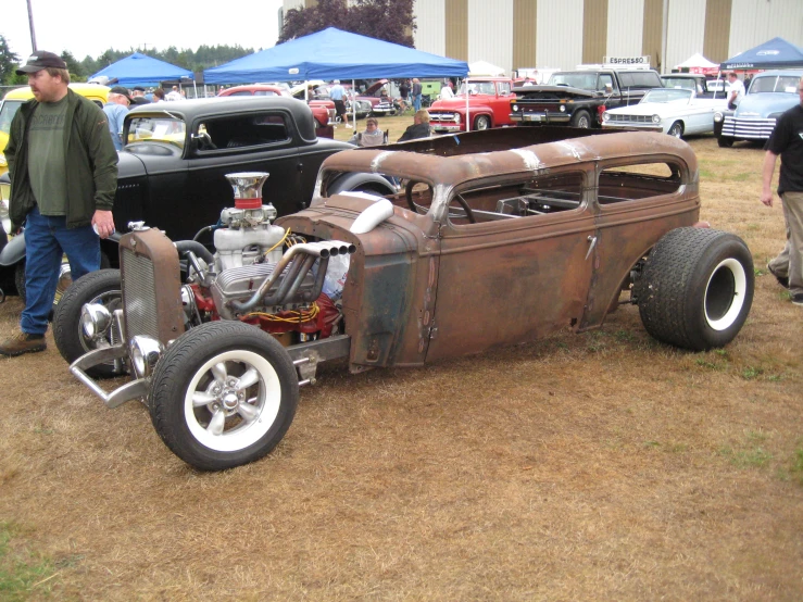 a car is parked with other classic vehicles