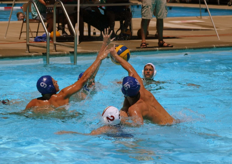 two people playing water polo on a swimming pool