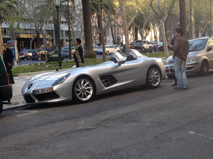a silver sports car is pulled over on the street