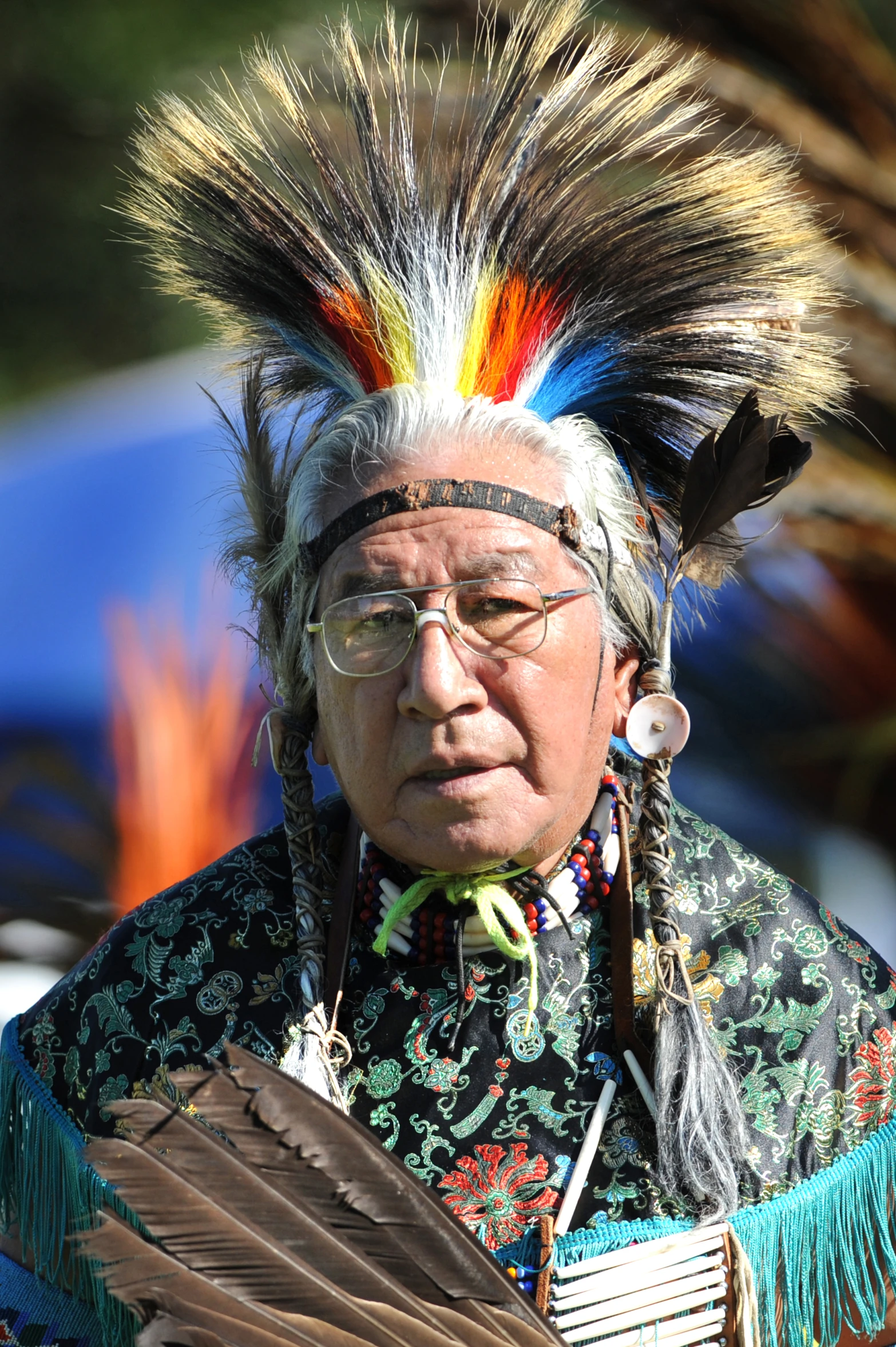 a native american indian looks at the camera