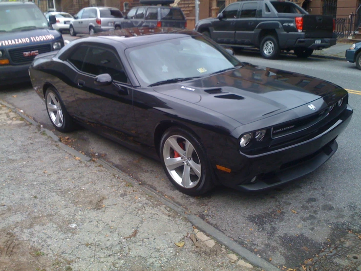 this black sports car is parked on the side of the street