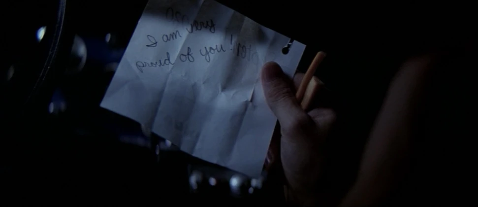 a note on paper held by someone's hand