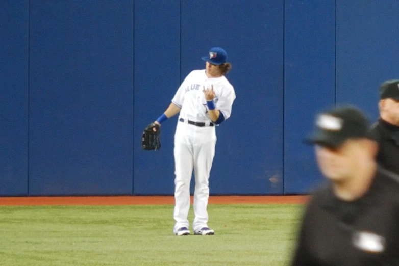 two men are standing on the field with baseball gloves on