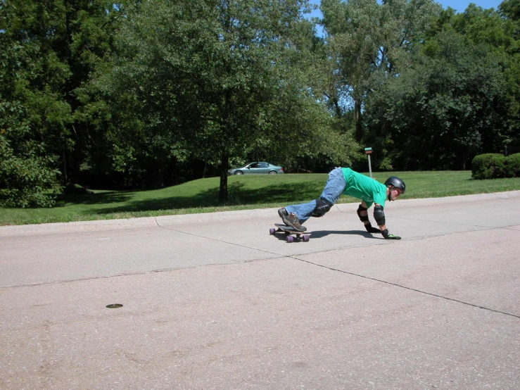 there is a man in green riding a skateboard